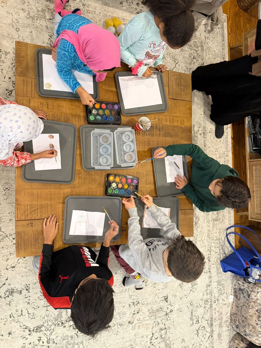 Children painting with watercolours during Islamic arts