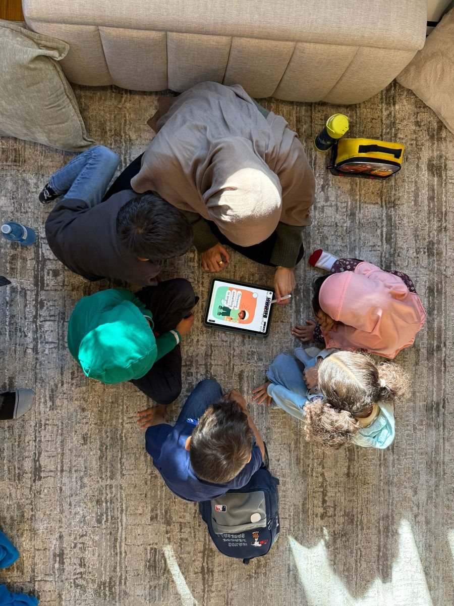 Small group learning together around a tablet