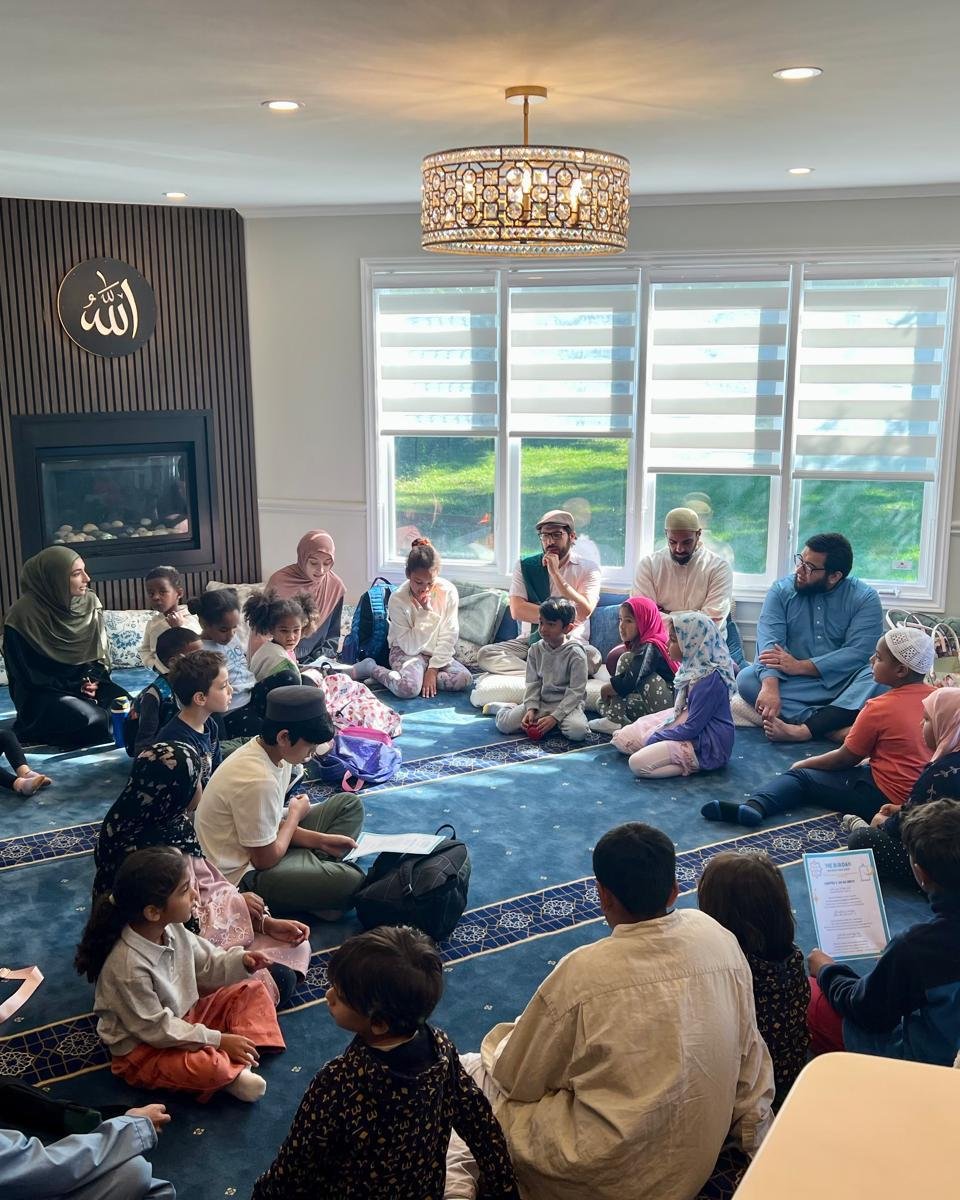 Families and children gathered in a learning circle at Al-Ihsan Learning Centre